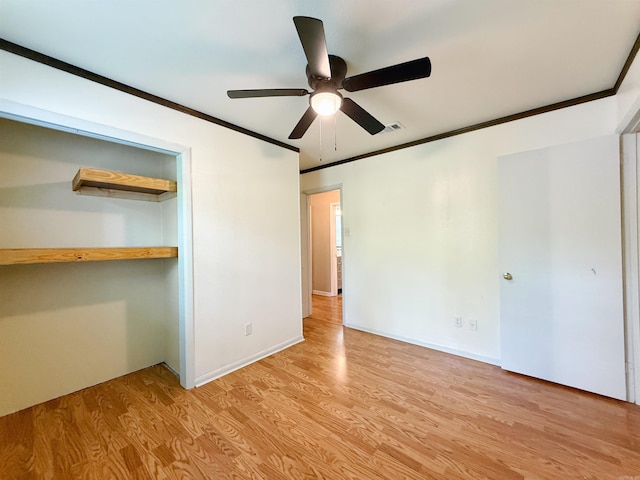 unfurnished bedroom featuring ornamental molding, a closet, and light wood-type flooring