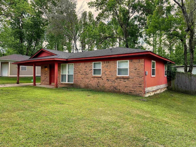 ranch-style house with brick siding, fence, and a front yard