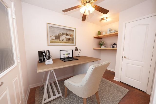 office space featuring built in desk, baseboards, and a ceiling fan
