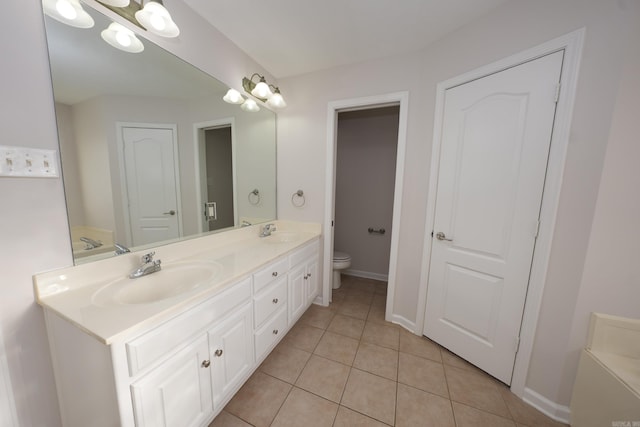 full bathroom featuring a sink, double vanity, toilet, and tile patterned floors