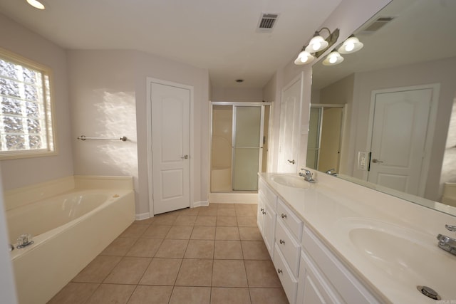 bathroom with tile patterned floors, visible vents, a shower stall, and a sink
