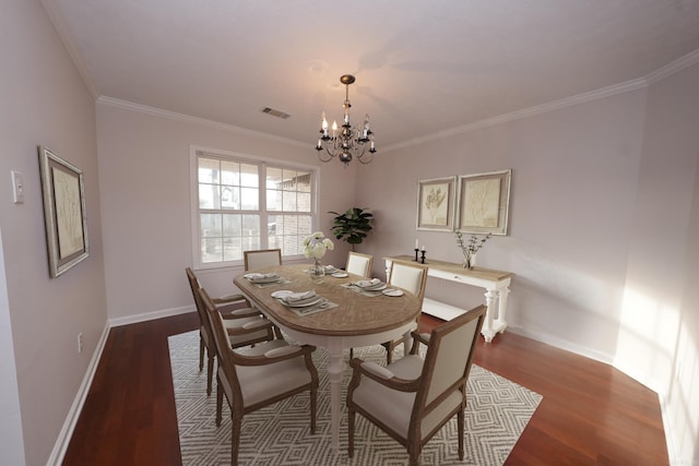 dining room featuring baseboards, dark wood finished floors, an inviting chandelier, and crown molding