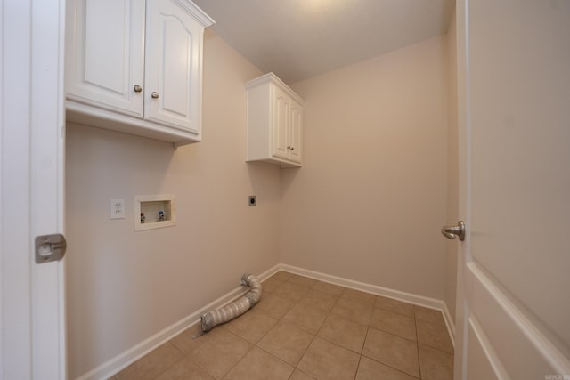 clothes washing area featuring cabinet space, light tile patterned flooring, electric dryer hookup, baseboards, and hookup for a washing machine
