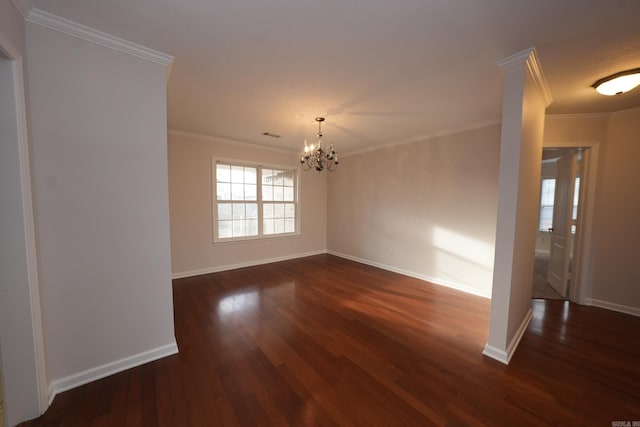 empty room featuring an inviting chandelier, crown molding, baseboards, and dark wood finished floors
