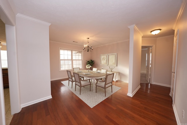 dining space featuring baseboards, a notable chandelier, crown molding, and wood finished floors