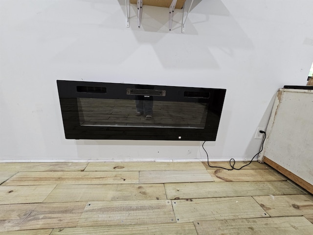 details featuring baseboards and wood finished floors