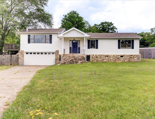 view of front of house featuring an attached garage, covered porch, stone siding, a front lawn, and driveway