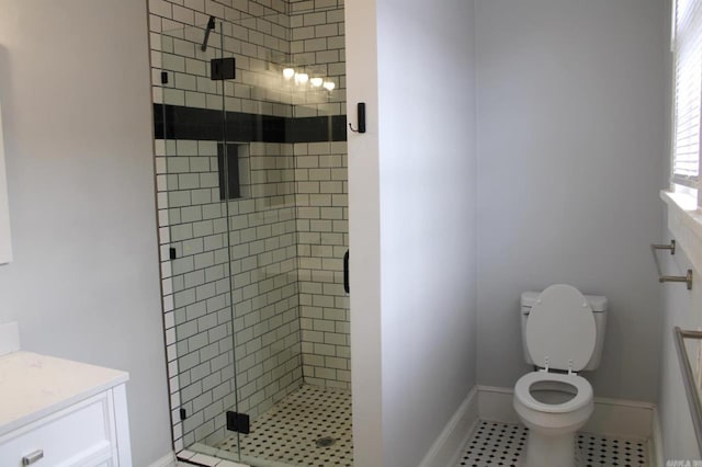315 W 22nd St, Little Rock, AR 72206 - bathroom featuring vanity, a shower stall, toilet, tile patterned floors, and baseboards