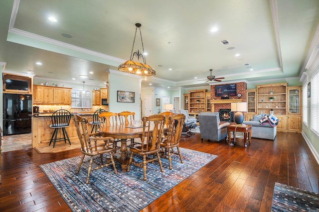 199 Gleneagle Loop, Hot Springs, AR 71913 - dining room with dark wood finished floors, plenty of natural light, a fireplace, and ceiling fan