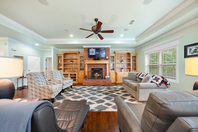 199 Gleneagle Loop, Hot Springs, AR 71913 - living area with visible vents, dark wood finished floors, ceiling fan, crown molding, and a brick fireplace