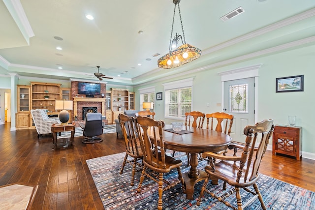 199 Gleneagle Loop, Hot Springs, AR 71913 - dining area featuring ornamental molding, visible vents, ceiling fan, a fireplace, and dark wood-style floors