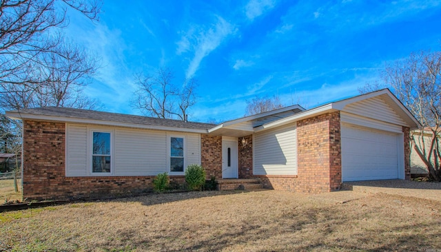 single story home with an attached garage, brick siding, driveway, and a front lawn