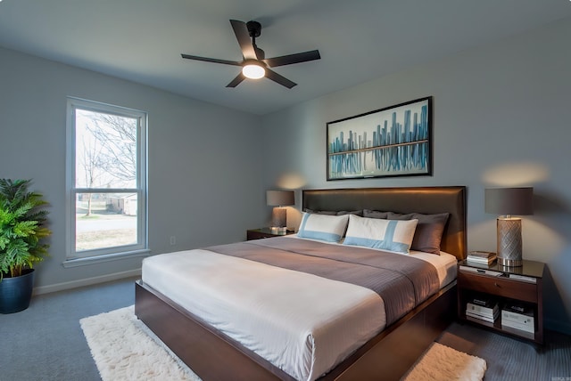 bedroom featuring carpet floors, baseboards, a ceiling fan, and multiple windows
