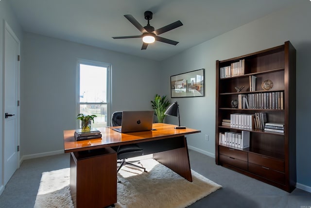 office area with baseboards, a ceiling fan, and carpet floors