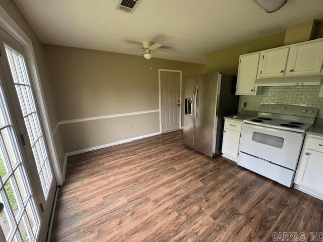 kitchen featuring under cabinet range hood, stainless steel fridge, white electric stove, and plenty of natural light