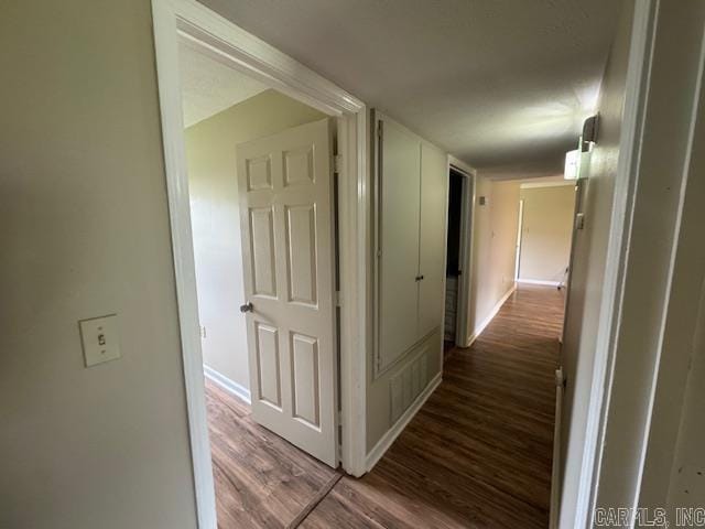 hall with wood finished floors and baseboards