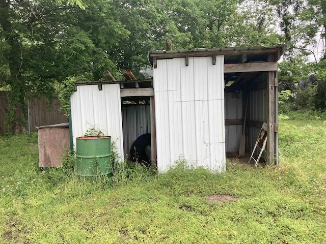 view of outdoor structure with an outbuilding and fence