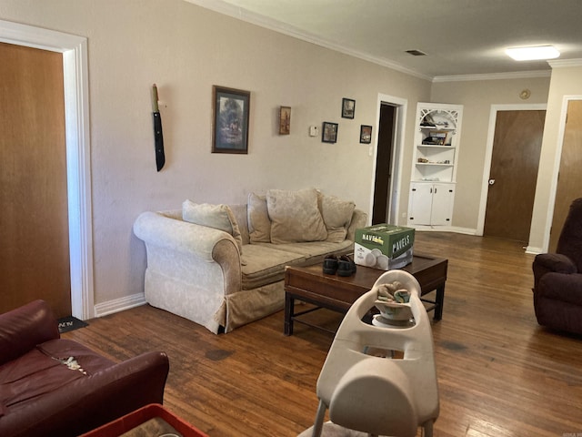 207 11th St, Mena, AR 71953 - living area featuring wood finished floors, ornamental molding, baseboards, and built in features