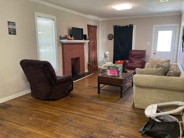 207 11th St, Mena, AR 71953 - living area with crown molding, wood-type flooring, a fireplace, and baseboards