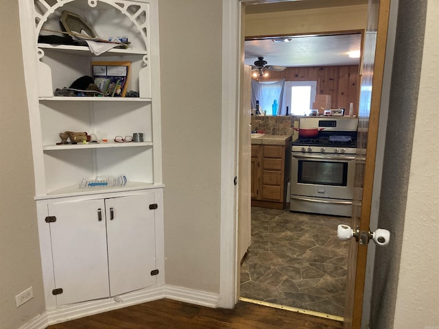 207 11th St, Mena, AR 71953 - hallway featuring dark wood-style floors, baseboards, and built in features