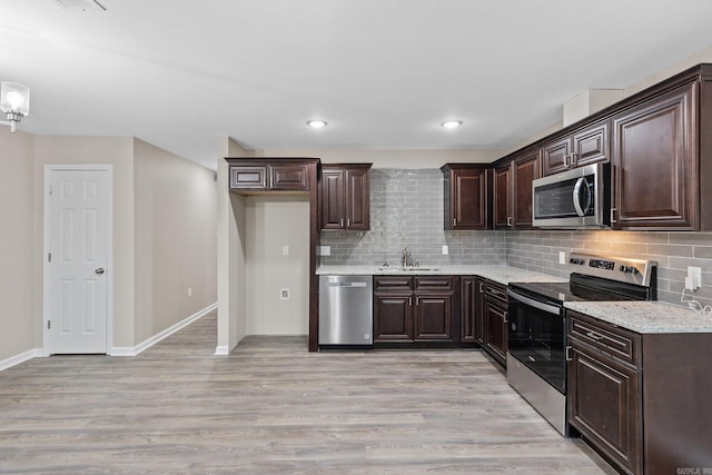 1914 Dennison St, Little Rock, AR 72202 - kitchen with stainless steel appliances, tasteful backsplash, a sink, and dark brown cabinetry