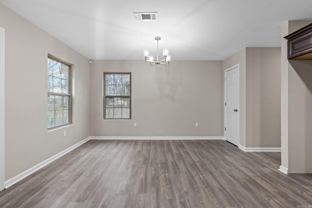 1914 Dennison St, Little Rock, AR 72202 - interior space with baseboards, dark wood-style flooring, and an inviting chandelier