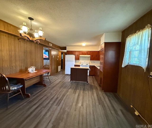 1300 Overdene St, Corning, AR 72422 - kitchen with a chandelier, light countertops, wood walls, and white appliances