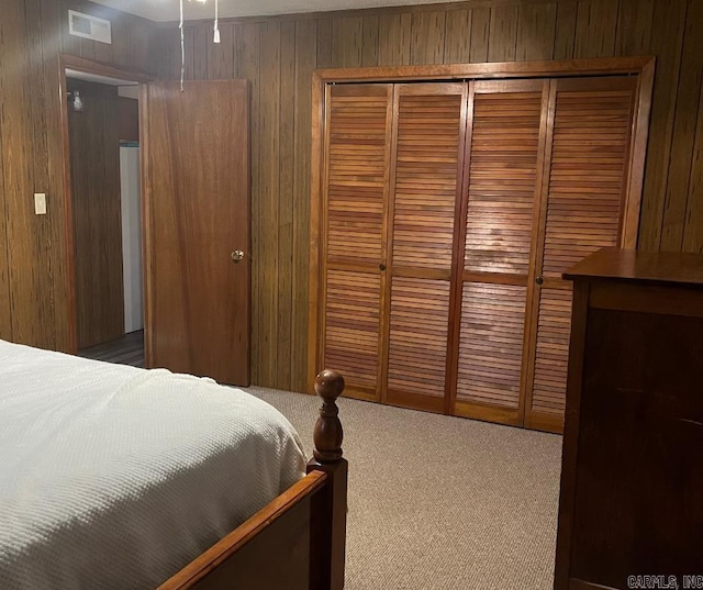 1300 Overdene St, Corning, AR 72422 - carpeted bedroom with wood walls, a closet, and visible vents