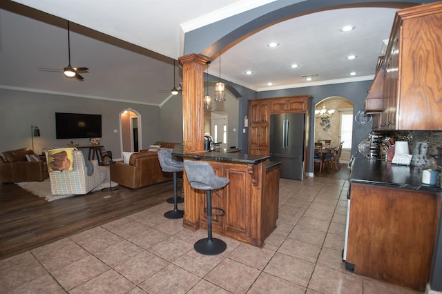 102 Cordell Rd, Beebe, AR 72012 - kitchen featuring dark countertops, freestanding refrigerator, arched walkways, and ceiling fan