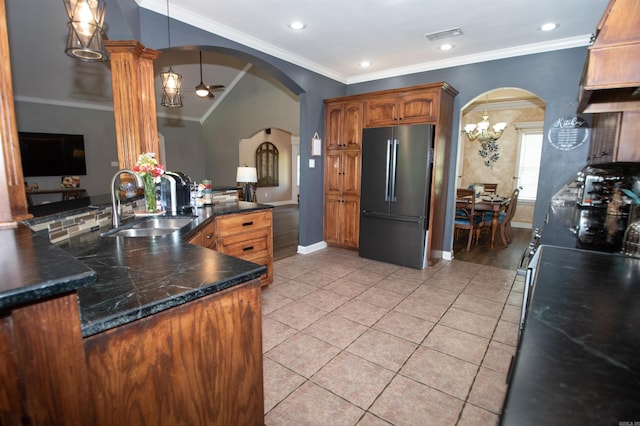 102 Cordell Rd, Beebe, AR 72012 - kitchen with freestanding refrigerator, baseboards, a sink, and arched walkways