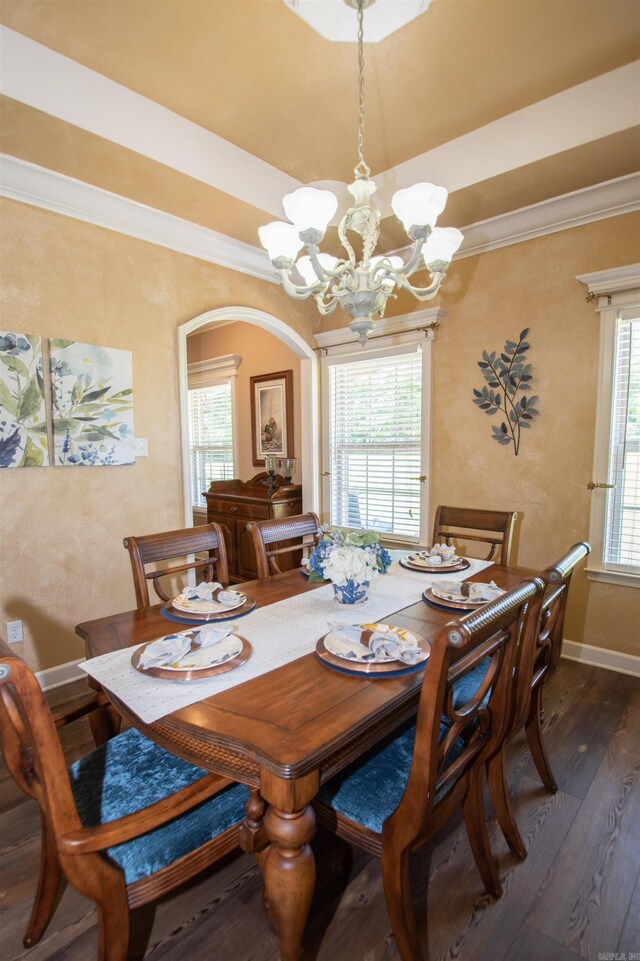 102 Cordell Rd, Beebe, AR 72012 - dining area featuring a notable chandelier, crown molding, dark wood-type flooring, baseboards, and arched walkways