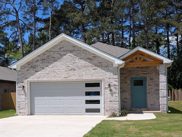 312 Frank T Bunton St, Lonoke, AR 72086 - view of front of home featuring concrete driveway, brick siding, fence, and an attached garage