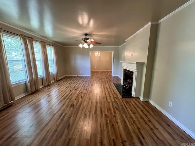 unfurnished living room with a ceiling fan, ornamental molding, a fireplace, and wood finished floors