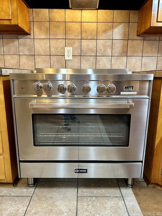 interior details with brown cabinetry and backsplash