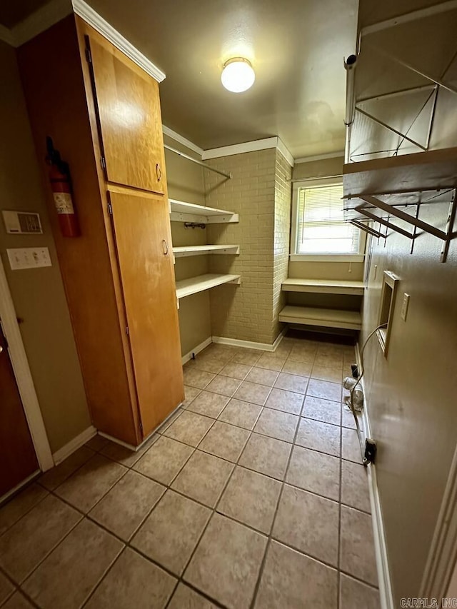 spacious closet featuring light tile patterned floors