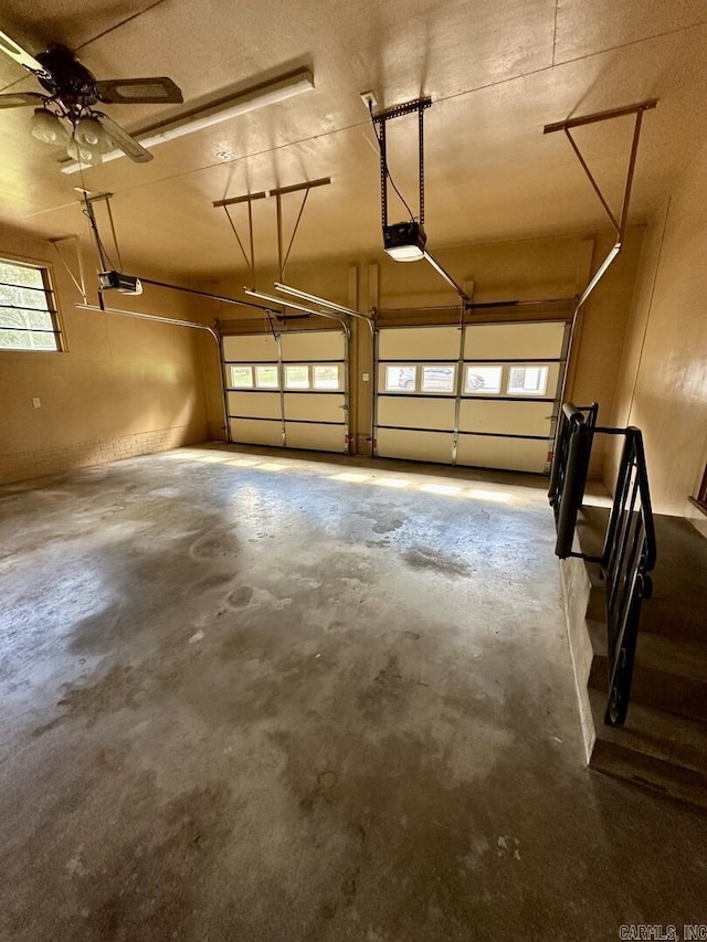 garage with ceiling fan and a garage door opener