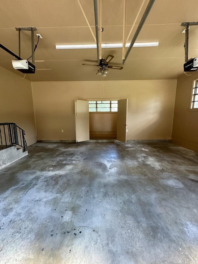 garage featuring a ceiling fan and a garage door opener