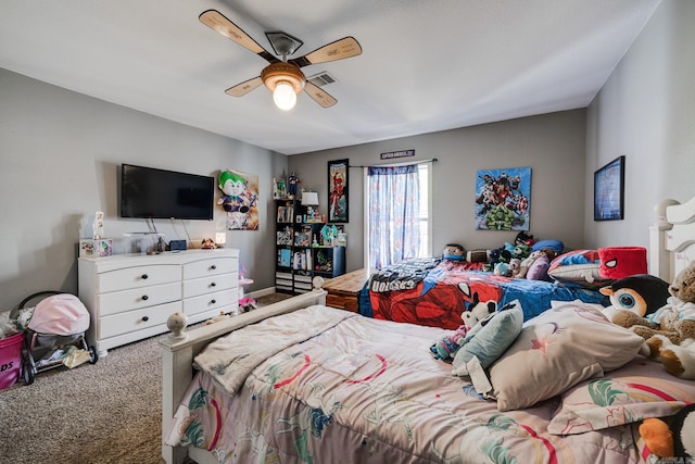 carpeted bedroom featuring a ceiling fan and visible vents