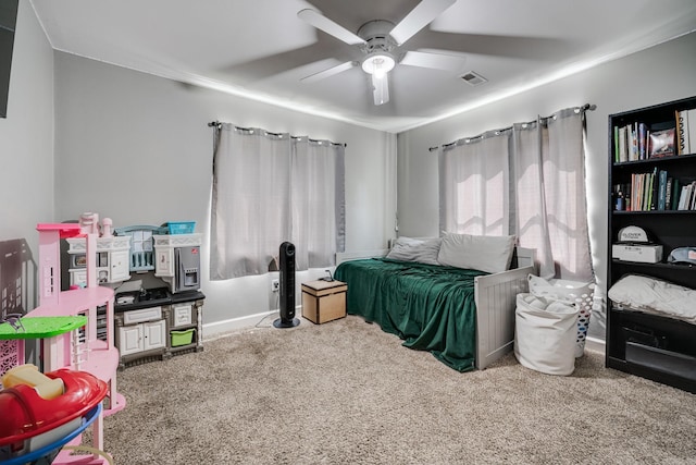 carpeted bedroom featuring a ceiling fan and visible vents