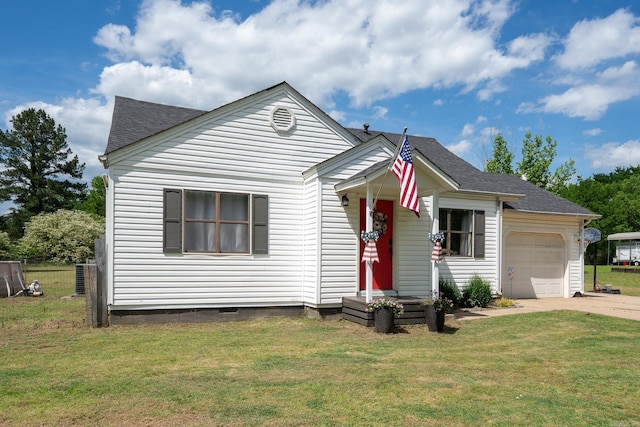 view of front facade with a front lawn, driveway, roof with shingles, and an attached garage