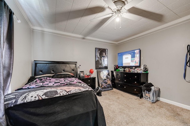 carpeted bedroom with crown molding, baseboards, and ceiling fan