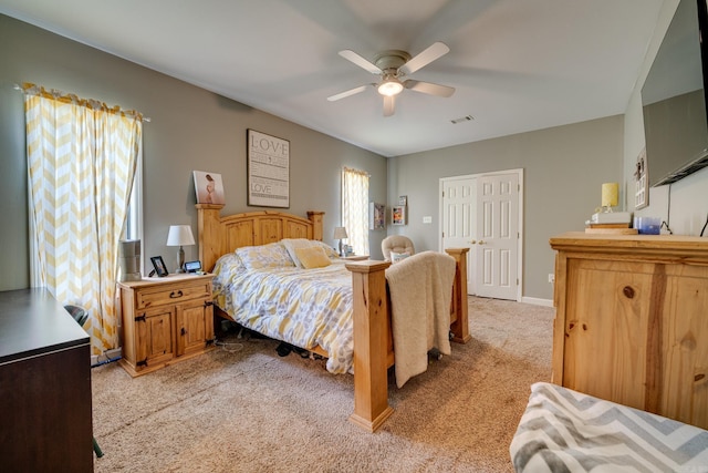 bedroom featuring ceiling fan, light carpet, baseboards, and visible vents