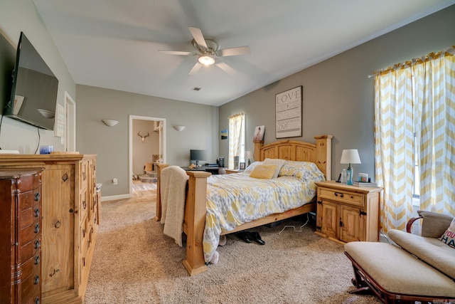 bedroom with light carpet, baseboards, a ceiling fan, and visible vents