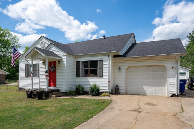 ranch-style home featuring concrete driveway, a front yard, roof with shingles, and a garage