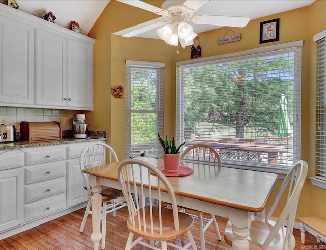 dining space featuring light wood finished floors and a ceiling fan