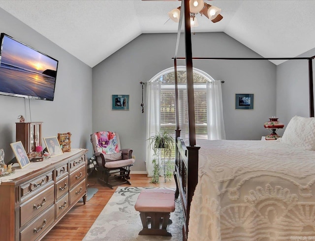 bedroom featuring lofted ceiling, light wood-style floors, and baseboards