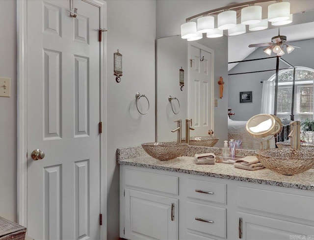 bathroom featuring vaulted ceiling, vanity, and a ceiling fan