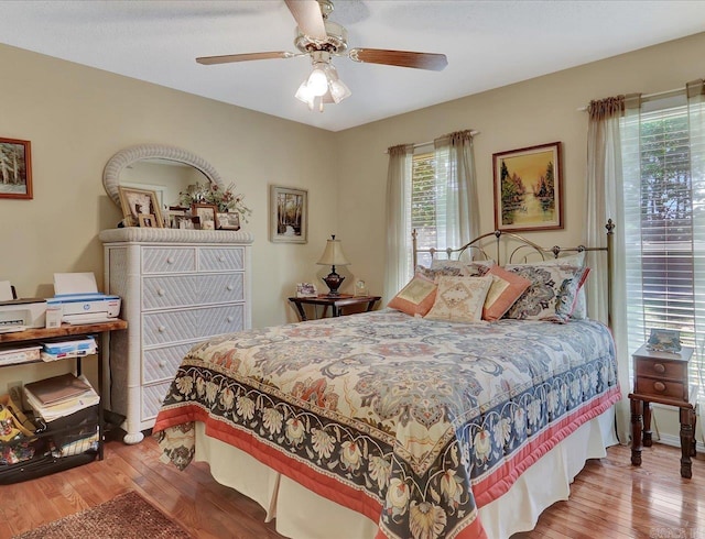 bedroom with wood finished floors and a ceiling fan