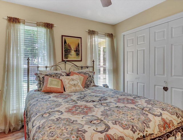 bedroom with a closet, a ceiling fan, and wood finished floors
