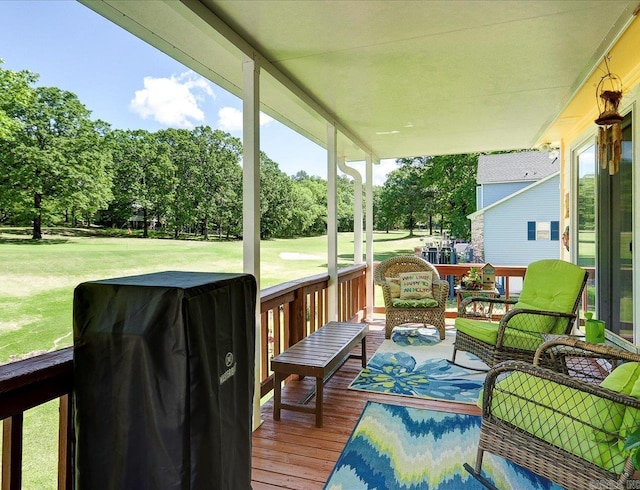 wooden deck with a lawn and an outdoor hangout area
